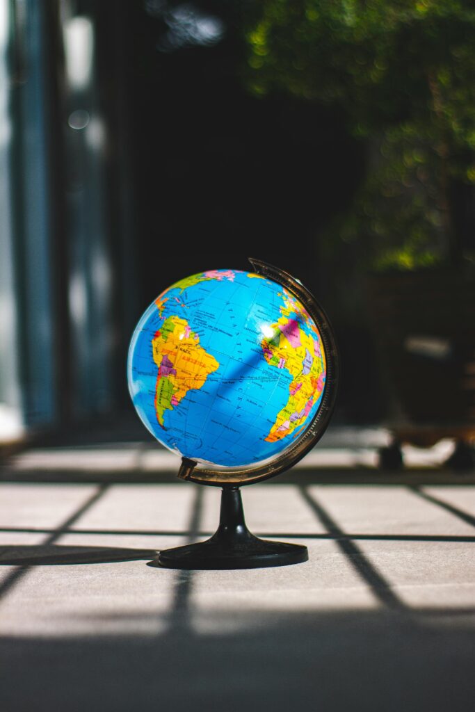 A vibrant world globe illuminated by sunlight, capturing global education themes.
